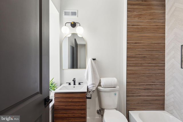 full bathroom with visible vents, toilet, and vanity