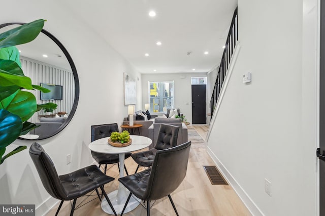 dining area featuring light wood-style flooring, stairs, visible vents, and recessed lighting