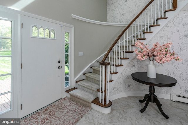 entryway featuring stairs, baseboard heating, and baseboards