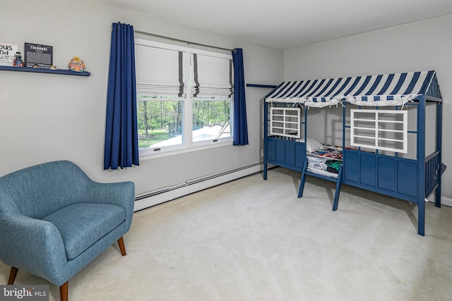 living area with a baseboard heating unit and carpet flooring