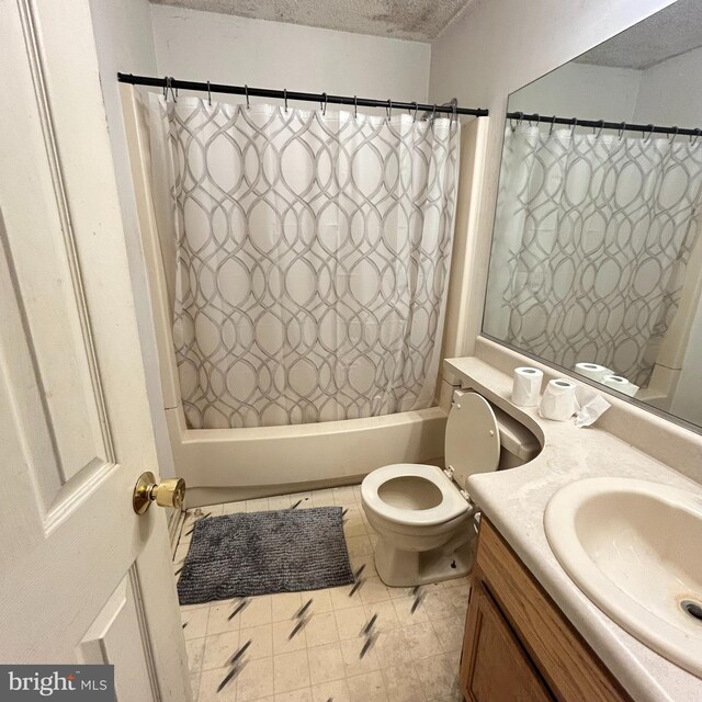 bathroom with shower / bath combination with curtain, vanity, a textured ceiling, and toilet