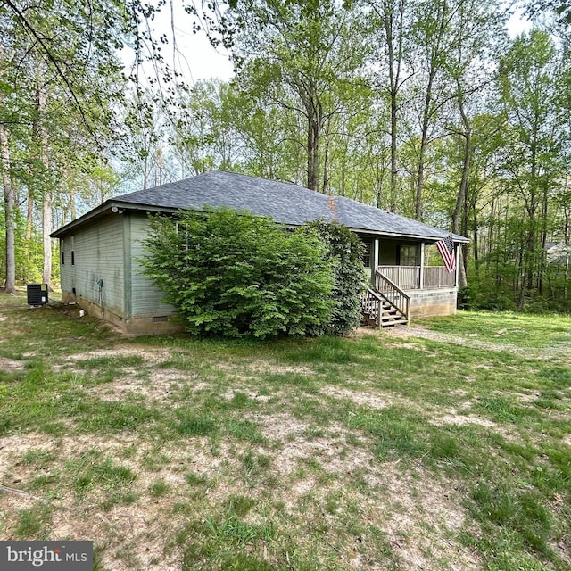 exterior space with central air condition unit, a porch, crawl space, and a shingled roof