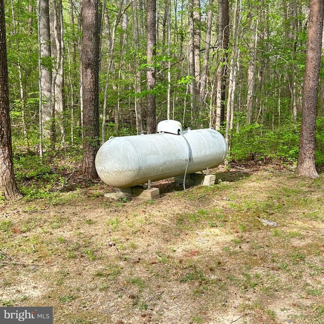 exterior details featuring a forest view and heating fuel