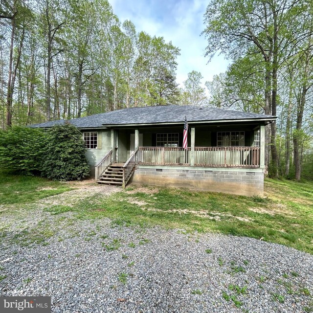 single story home featuring covered porch and roof with shingles