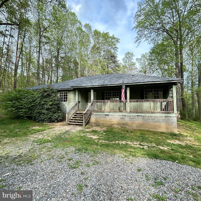 view of front of home featuring covered porch and roof with shingles