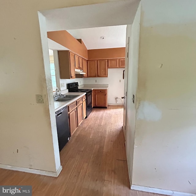 kitchen featuring brown cabinetry, black electric range, dishwasher, light wood-style flooring, and under cabinet range hood