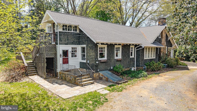 0 Winchester, Warrenton, VA 20186 - view of front of home featuring a shingled roof, a chimney, and stairway