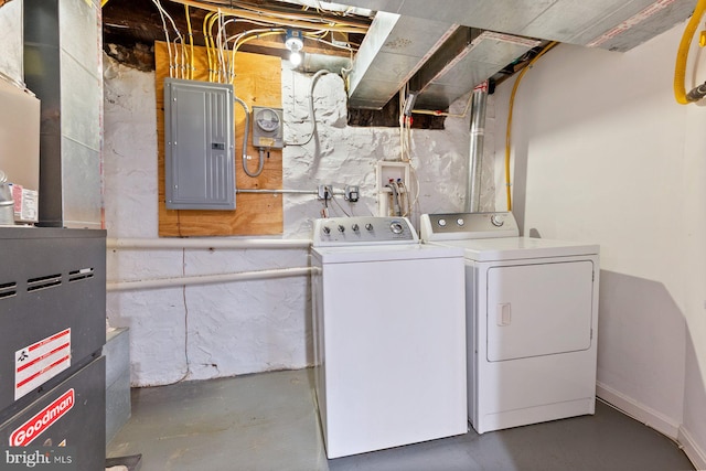 clothes washing area featuring separate washer and dryer, laundry area, and electric panel