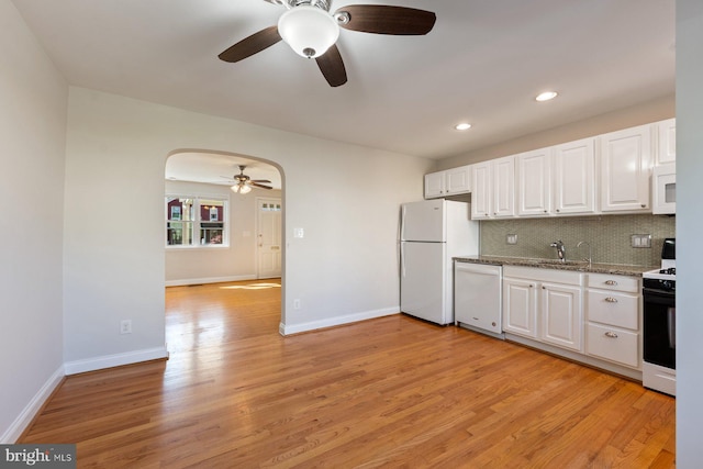 kitchen with light wood-type flooring, a ceiling fan, white cabinets, and white appliances