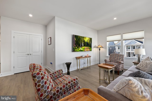 living room featuring baseboards, wood finished floors, and recessed lighting