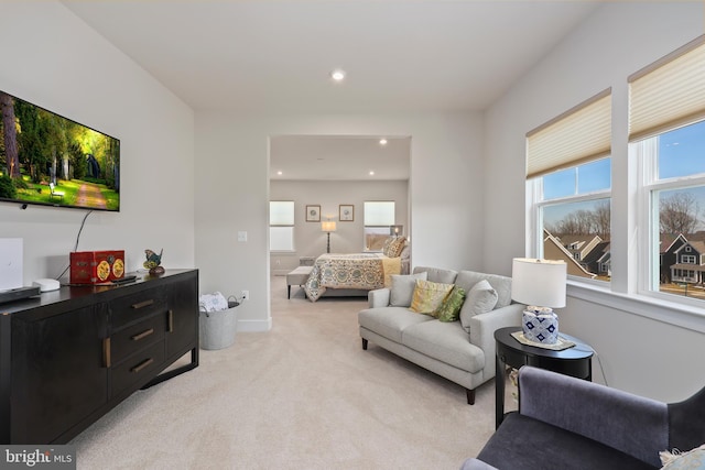 living room with recessed lighting and light colored carpet
