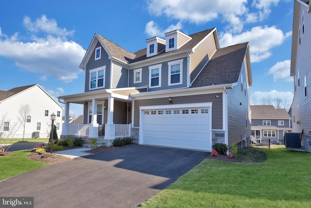 view of front of house with aphalt driveway, an attached garage, a porch, a front yard, and roof with shingles