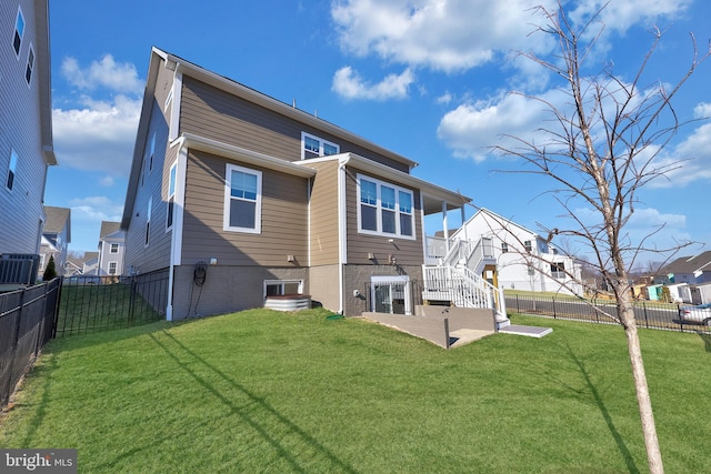 back of house with stairs, a fenced backyard, a yard, central AC, and a patio
