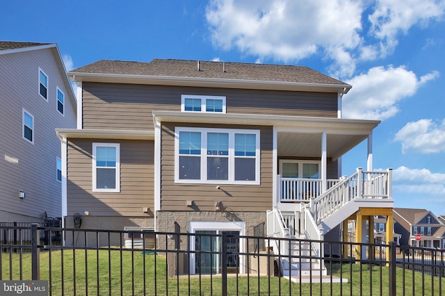 rear view of house featuring stairway, a yard, and fence private yard