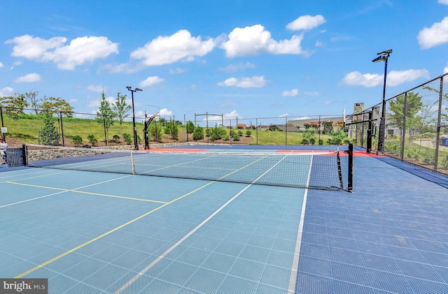 view of sport court featuring community basketball court and fence