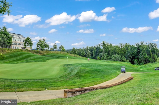 view of home's community with a yard and golf course view