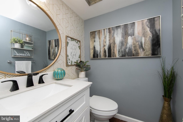 bathroom with visible vents, toilet, and vanity