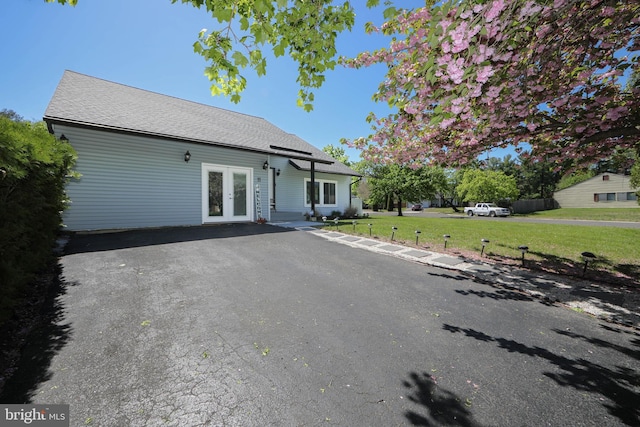 view of front facade featuring french doors and a front yard