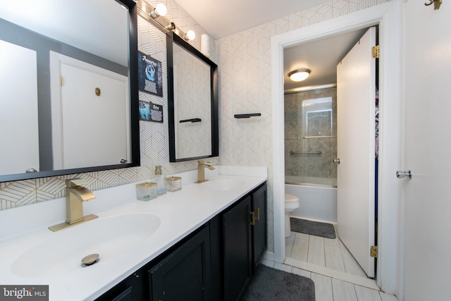 bathroom with a sink, tile patterned flooring, toilet, and double vanity