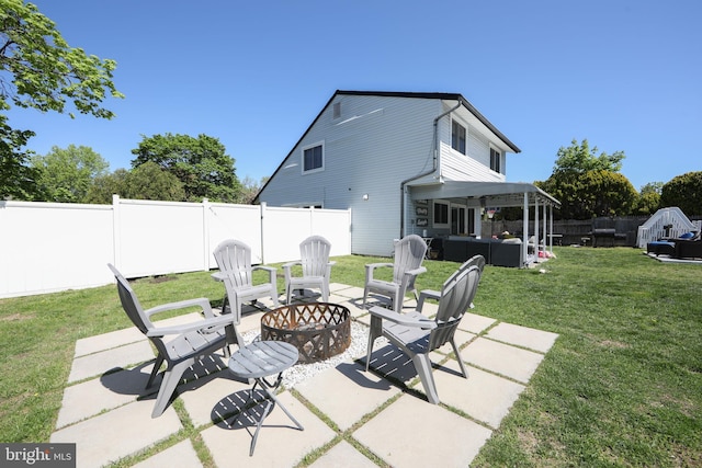 view of patio / terrace with a fenced backyard and an outdoor living space with a fire pit