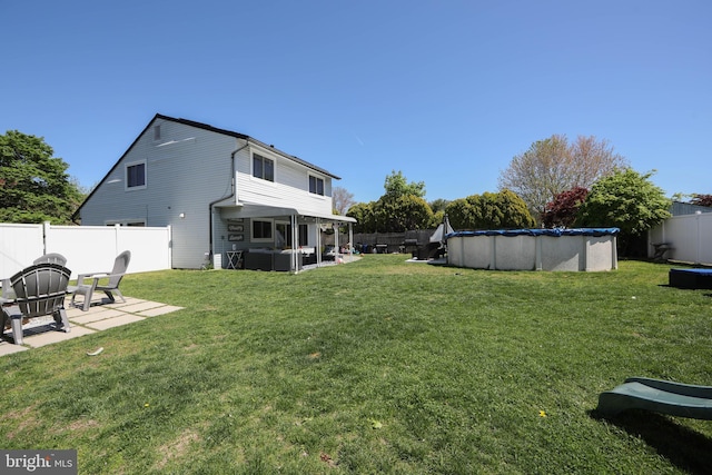 view of yard with an outdoor living space, a fenced in pool, a fenced backyard, and a patio area