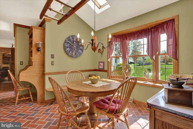 dining area with baseboards, brick floor, and lofted ceiling with skylight