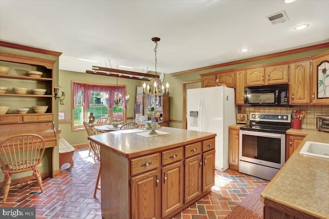 kitchen with electric stove, black microwave, white fridge with ice dispenser, light countertops, and brick floor