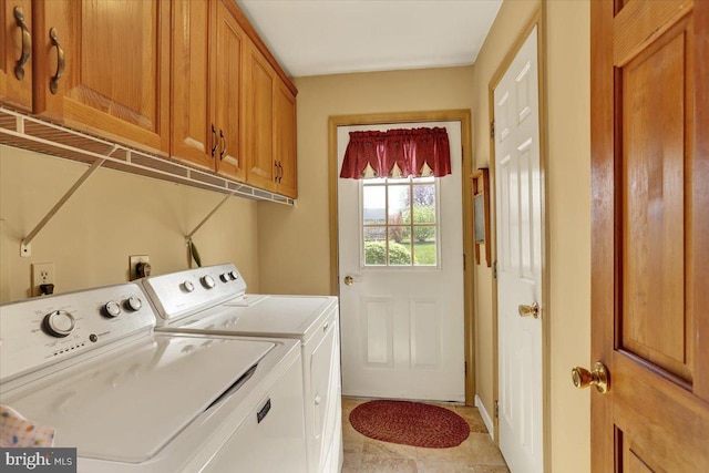 washroom with separate washer and dryer and cabinet space