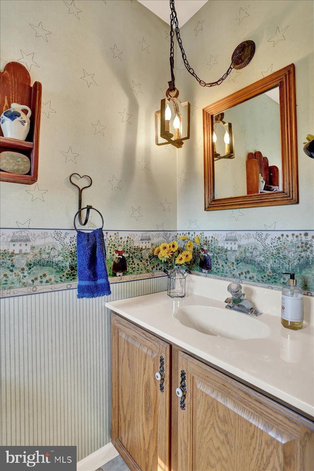bathroom with wallpapered walls and vanity