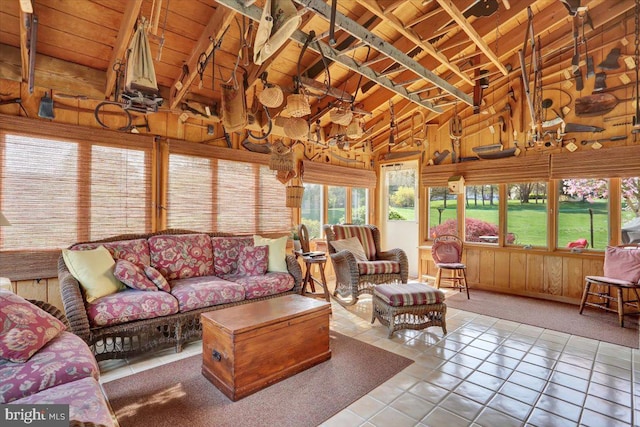 tiled living room with wooden walls, wooden ceiling, and vaulted ceiling with beams