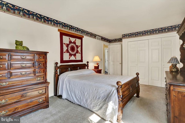 carpeted bedroom featuring a closet and visible vents