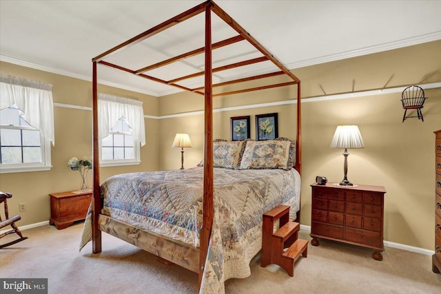 carpeted bedroom featuring ornamental molding and baseboards