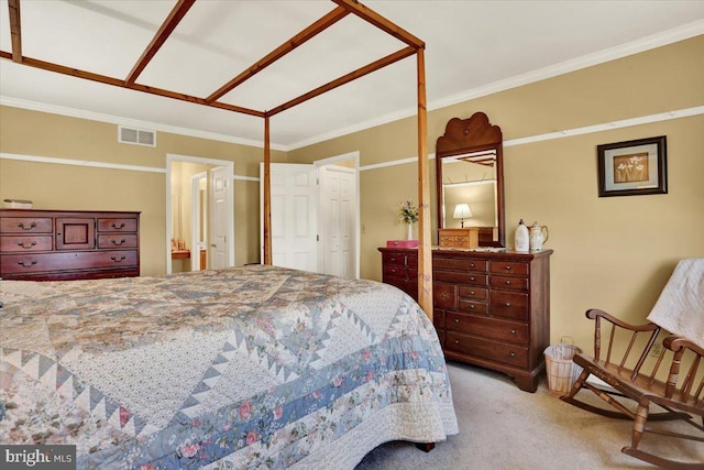 bedroom featuring ornamental molding, visible vents, carpet floors, and ensuite bathroom