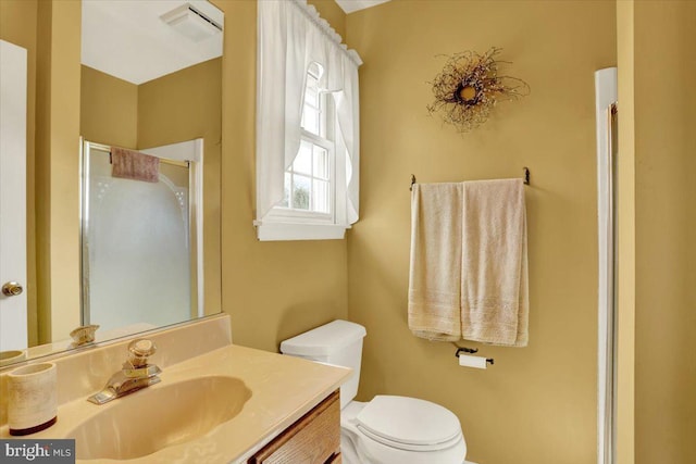 full bathroom with visible vents, an enclosed shower, toilet, and vanity