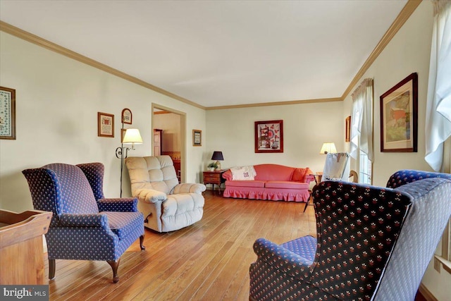 living area featuring crown molding and hardwood / wood-style floors
