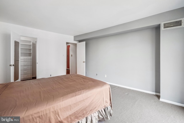 carpeted bedroom with baseboards and visible vents