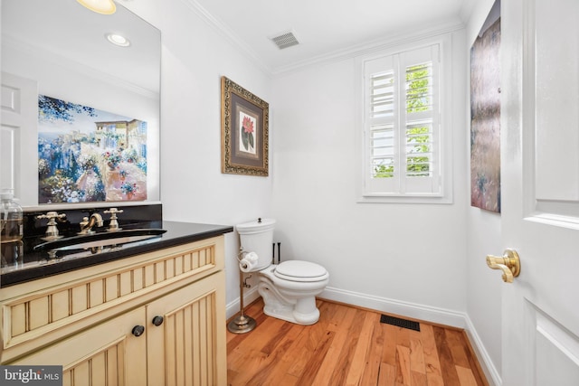 13543 Rustling Oaks Dr, Wye Mills, MD 21679 - half bath with baseboards, wood finished floors, toilet, vanity, and ornamental molding