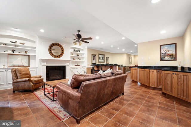 13543 Rustling Oaks Dr, Wye Mills, MD 21679 - living area featuring a ceiling fan, crown molding, a glass covered fireplace, built in shelves, and recessed lighting