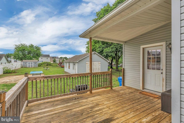 10 Turner Ave, Swedesboro, NJ 08085 - wooden deck featuring an outdoor structure, a storage unit, and a residential view