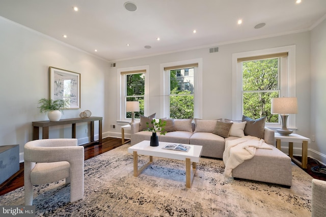 living room with recessed lighting, wood finished floors, visible vents, crown molding, and baseboards