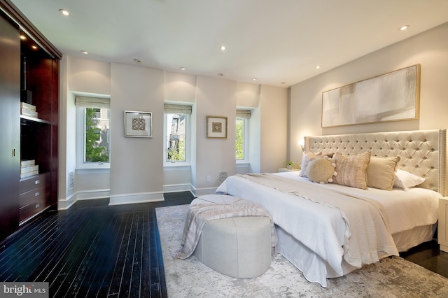 bedroom with baseboards, dark wood-style floors, and recessed lighting