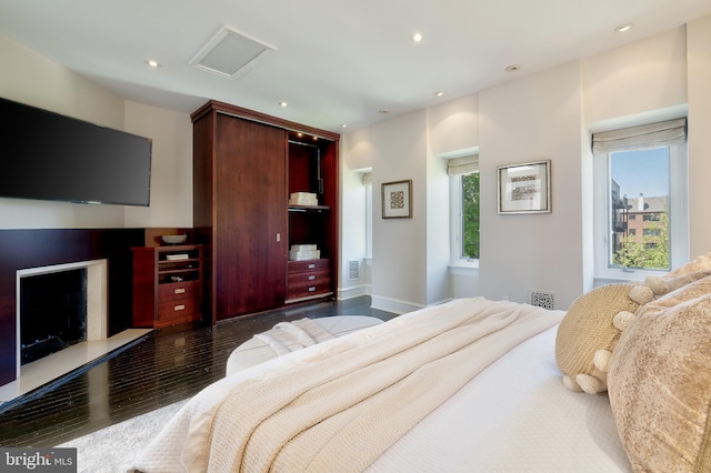 bedroom featuring attic access, wood finished floors, visible vents, and recessed lighting