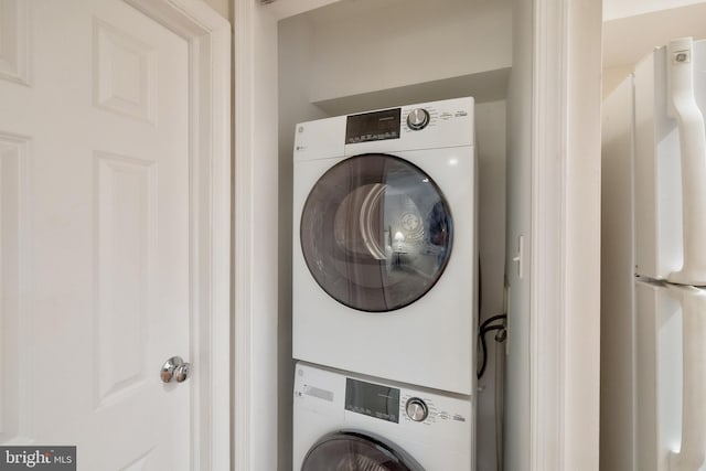 washroom featuring stacked washer / dryer