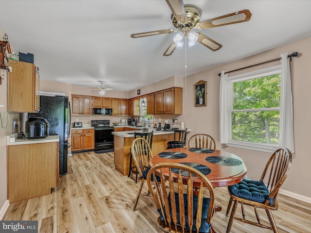 3322 Johnsons Mill Rd, Berkeley Springs, WV 25411 - dining area with ceiling fan, light wood finished floors, and plenty of natural light
