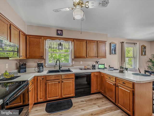 3322 Johnsons Mill Rd, Berkeley Springs, WV 25411 - kitchen with black appliances, a sink, a peninsula, and light countertops