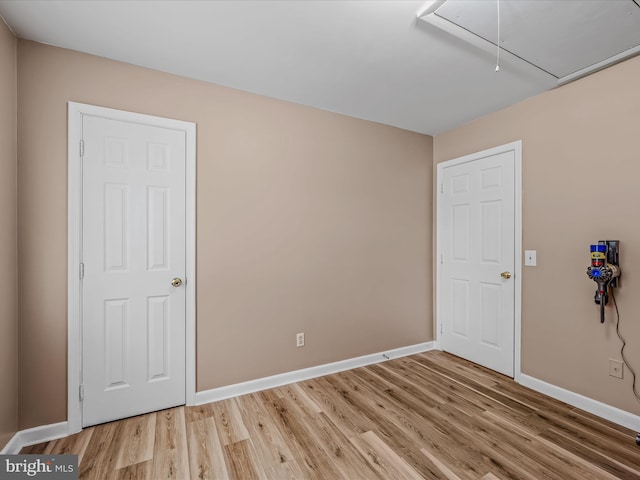 3322 Johnsons Mill Rd, Berkeley Springs, WV 25411 - spare room featuring attic access, light wood-style flooring, and baseboards