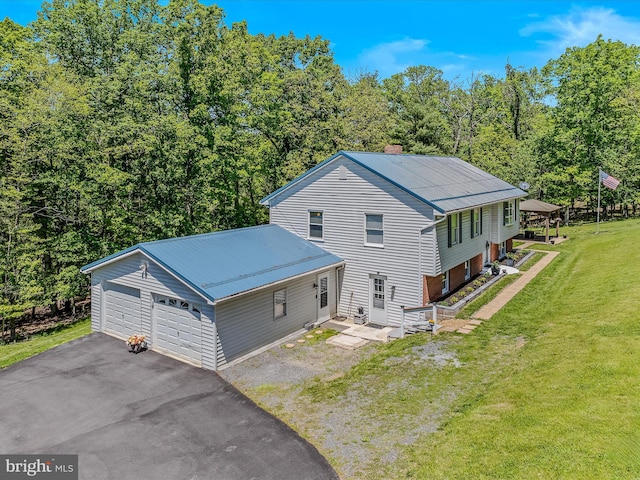 3322 Johnsons Mill Rd, Berkeley Springs, WV 25411 - view of front of property featuring metal roof, a front lawn, a chimney, and a garage