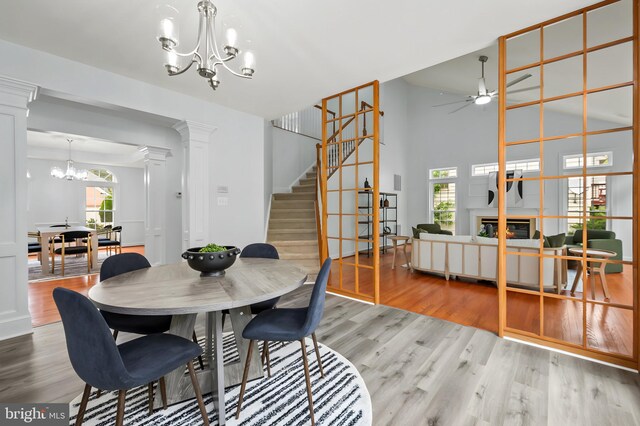 13017 English Turn Dr, Silver Spring, MD 20904 - dining area featuring stairs, a healthy amount of sunlight, wood finished floors, and ceiling fan with notable chandelier