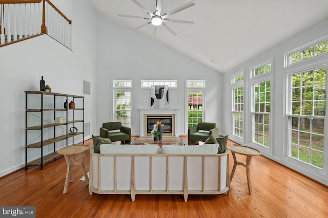 13017 English Turn Dr, Silver Spring, MD 20904 - living room featuring visible vents, wood finished floors, a fireplace, high vaulted ceiling, and a ceiling fan