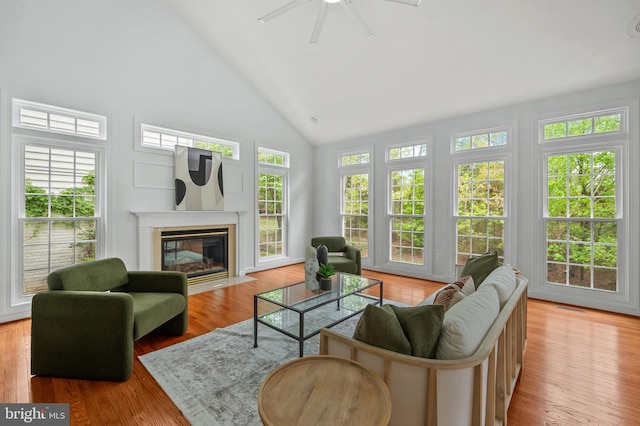13017 English Turn Dr, Silver Spring, MD 20904 - living area featuring a fireplace with flush hearth, ceiling fan, wood finished floors, and high vaulted ceiling